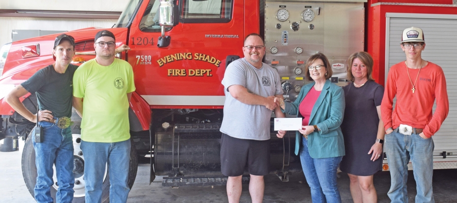 NAEC Vice President of Member Services Leah Rouse presents Evening Shade Fire Department with an Operation Round Up donation.